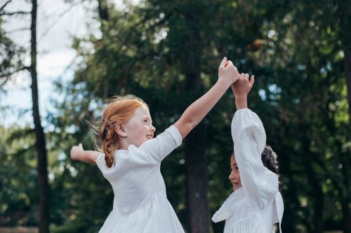 two young girls plating in the park